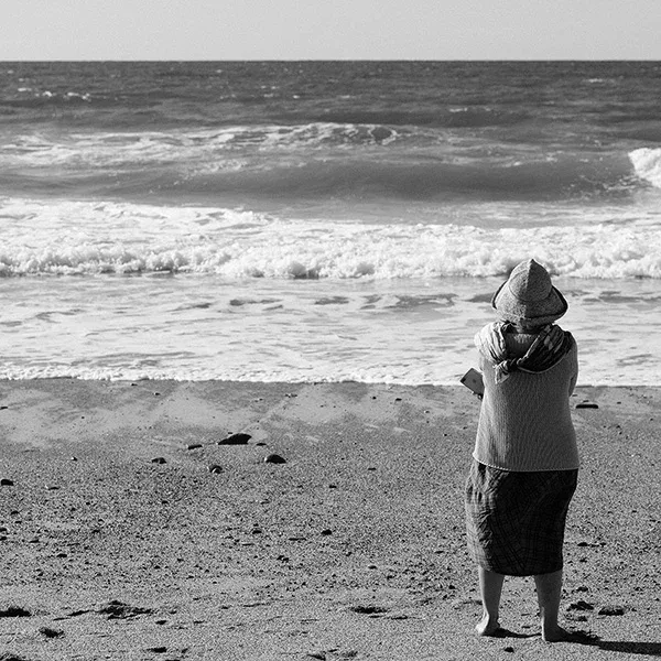 Woman on the beach with a view of the sea, artistic street photography