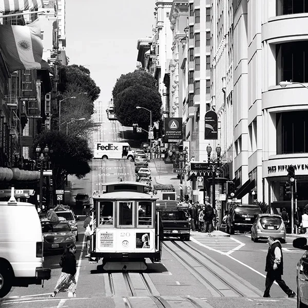 A cable car travels through the steep streets of San Francisco - artistic street photography full of dynamism.